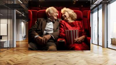 Elderly couple hugging while watching a film in cinema. Senior man and senior woman having a date at movie theater. Hobbies in retirement. Wall mural