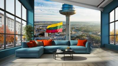 Giant tricolor Lithuanian flag waving on Vilnius television tower on the celebration of Restoration of the State Day. Wall mural