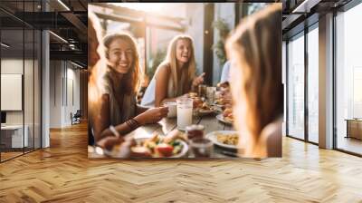 Group of cheerful friends having fun at dinner party. Multi-ethnic people having a get together outdoors. Wall mural