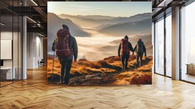 Group of male hikers admiring a scenic view from a mountain top. Adventurous young men with backpacks. Hiking and trekking on a nature trail. Traveling by foot. Wall mural