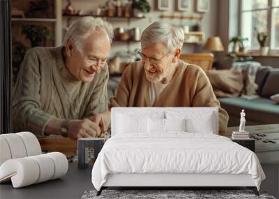 Senior couple playing puzzles in a retirement home. Elderly friends assembling jigsaw puzzle pieces in a nursing home. Housing facility intended for the elderly people. Wall mural