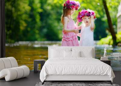 Two little sisters wearing flower crowns Wall mural