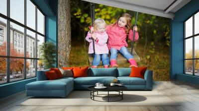 Two sisters swinging outdoors Wall mural