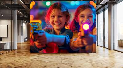 Two ten year old kids playing laser tag in an indoor space. Children wearing goggles and holding laser guns. Active and fun leisure for big kids and teenagers. Wall mural