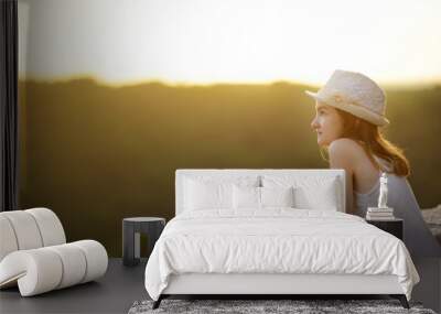 Young girl enjoying sunset view in the famous Pitigliano town, located atop a volcanic tufa ridge. Beautiful italian towns and villages. Etruscan heritage, Grosseto, Italy. Wall mural