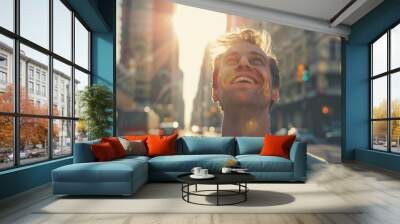 A happy young caucasian man looking up at the sky alone in a busy city, sun shining Wall mural