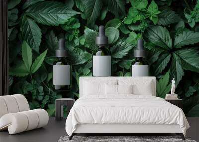 White dropper bottles with white labels, surrounded by green leaves  Wall mural