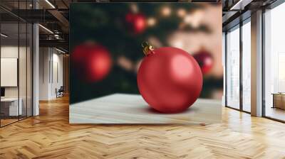 Mockup of red ornaments ball decoration  on wooden table over Christmas tree Wall mural