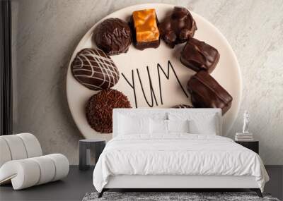 Dark chocolates on Yum plate Wall mural