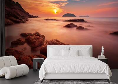 Long exposure photo of a warm sunset on the rocky beach of Redang Island, Malaysia Wall mural