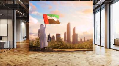 Emirati Arab man holding UAE flag, celebrating the national day Wall mural