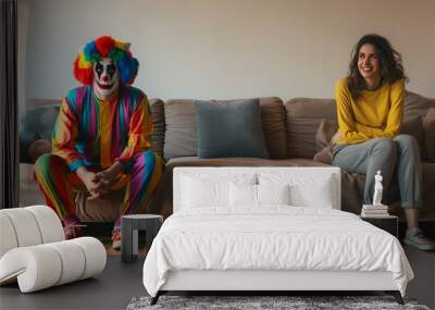 A clown with a sad expression sits on a sofa near a beautiful happy woman, the clown is wearing colorful clothes but his face looks sad, Ai generated images Wall mural