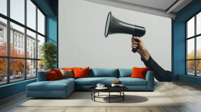 Hand holding a megaphone on a clean white background, Ai generated Images Wall mural