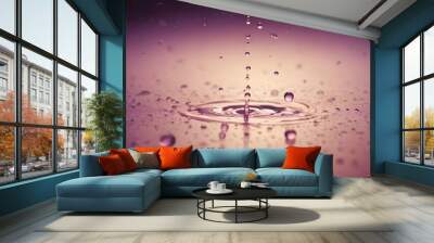 Macro photography of water droplets with a pink background, creating a sense of depth and clarity. Wall mural