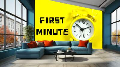 Text FIRST MINUTE with alarm clock on yellow background. Wall mural