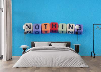 A word NOTHING made by a colourful cube beads alphabet  over blue background. Wall mural