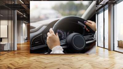 Close up hands of woman driving a car.. Wall mural