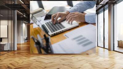 Close up of businessperson using laptop working with digital data. Wall mural