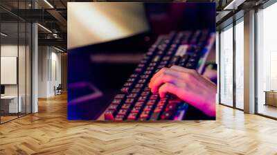 Close up of hands using keyboard for Online video game . Wall mural