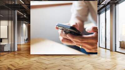 Close up of person looking at mobile phone, Online social addict.. Wall mural