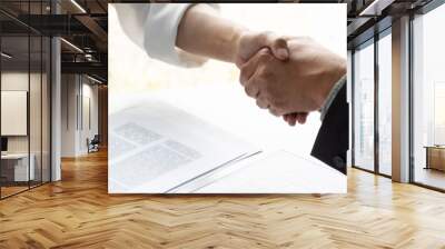 Lawyer and client handshake with contract agreement signing in law firm. Wall mural