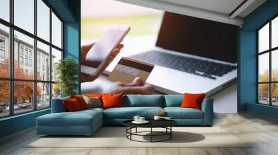 Male hand using credit card with laptop pc, Online shopping and payment concept. Wall mural