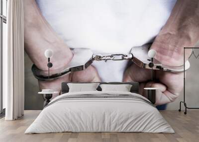 Male hands arrested with handcuffs in Criminal concept. Wall mural