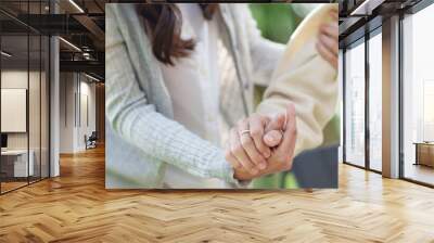 Nursing home, Young caregiver helping senior woman in wheelchair, Volunteer. Wall mural