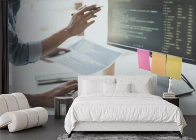 programmer writing program code with two monitors and working on a new software or hacker programming developing software applications Wall mural