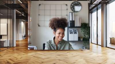 Young afro african american millennial employee trainee working on office desk. Wall mural