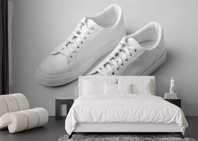 A pair of sleek white sneakers with a minimalist design, isolated on a light gray background. Wall mural