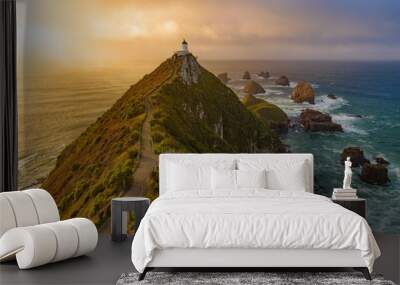 Nugget Point and lighthouse with sunrise at South Island, New Zealand Wall mural