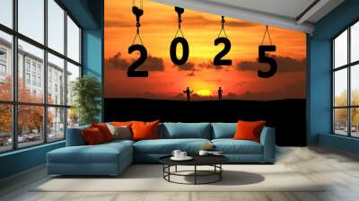 Concept Happy new year Silhouette of engineer and construction to create lifting crane 2025 on sunrise background. Wall mural