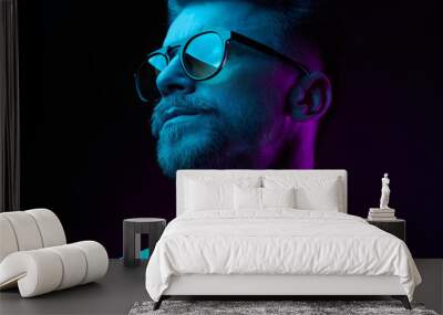 neon light studio close-up portrait of serious man model with mustaches and beard in sunglasses and  Wall mural