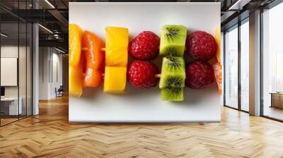 Colorful fruit skewers arranged on a platter, vibrant assortment of fresh fruits, clean presentation, appealing visual treat against a bright white background. Wall mural