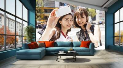 two young ladies are shooting at the intersection of shibuya Wall mural