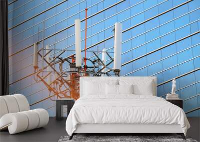 Cellular network antenna with background of windows of high building and beautiful sunlight Wall mural