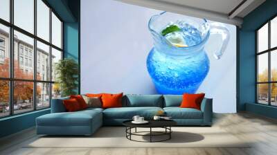 Iced Italian blue soda served in a jug on white background Wall mural