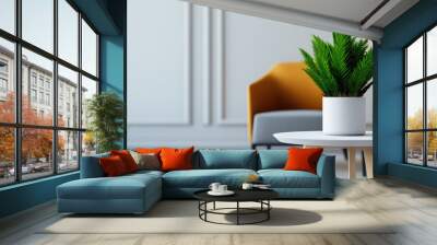 Indoor tranquility, a green plant in a textured white pot on a light wood table, brightens a modern living room with an orange accent chair and neutral walls. Wall mural