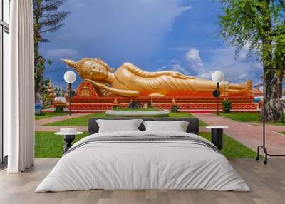 A reclining Buddha statue at Wat Pha That Luang lacated in Vientiane, Loas Wall mural