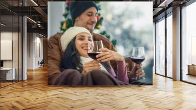 couple have romantic moment and have wine together at home in winter Wall mural