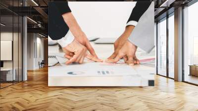 hands and fingers of businesspeople pointing at one point on meeting table in concept of aiming together on same business target Wall mural