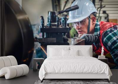 industrial background of caucasian mechanics engineer operating lathe machine for metalwork in metal work factory Wall mural