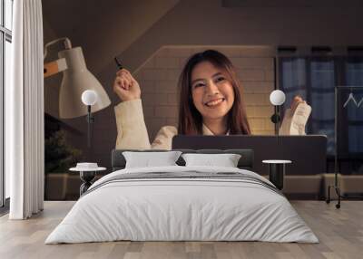 joyful woman celebrating success at her laptop in a home office Wall mural