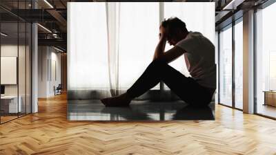 man sitting alone at home looking sorrow with desperate and depressed Wall mural