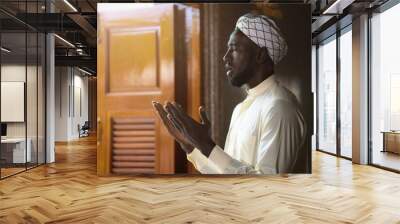 muslim man having worship and praying for allah blessing in islam ceremony in mosque during islamic ramadan period Wall mural