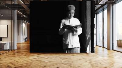 muslim student standing in islamic mosque studying Al quran book Wall mural