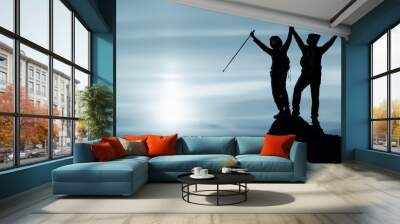 silhouette of two friends having achievement climbing up mountain to the peak together Wall mural