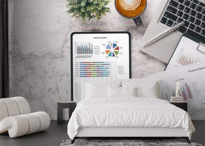 Tablet with charts and reports on office desk workplace. Top view flat lay.. Wall mural