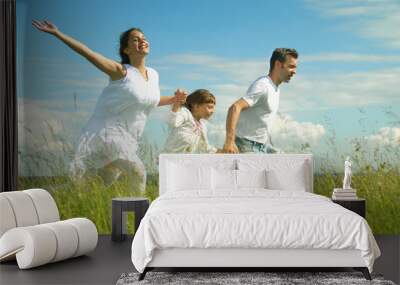 Happy family run on meadow Wall mural